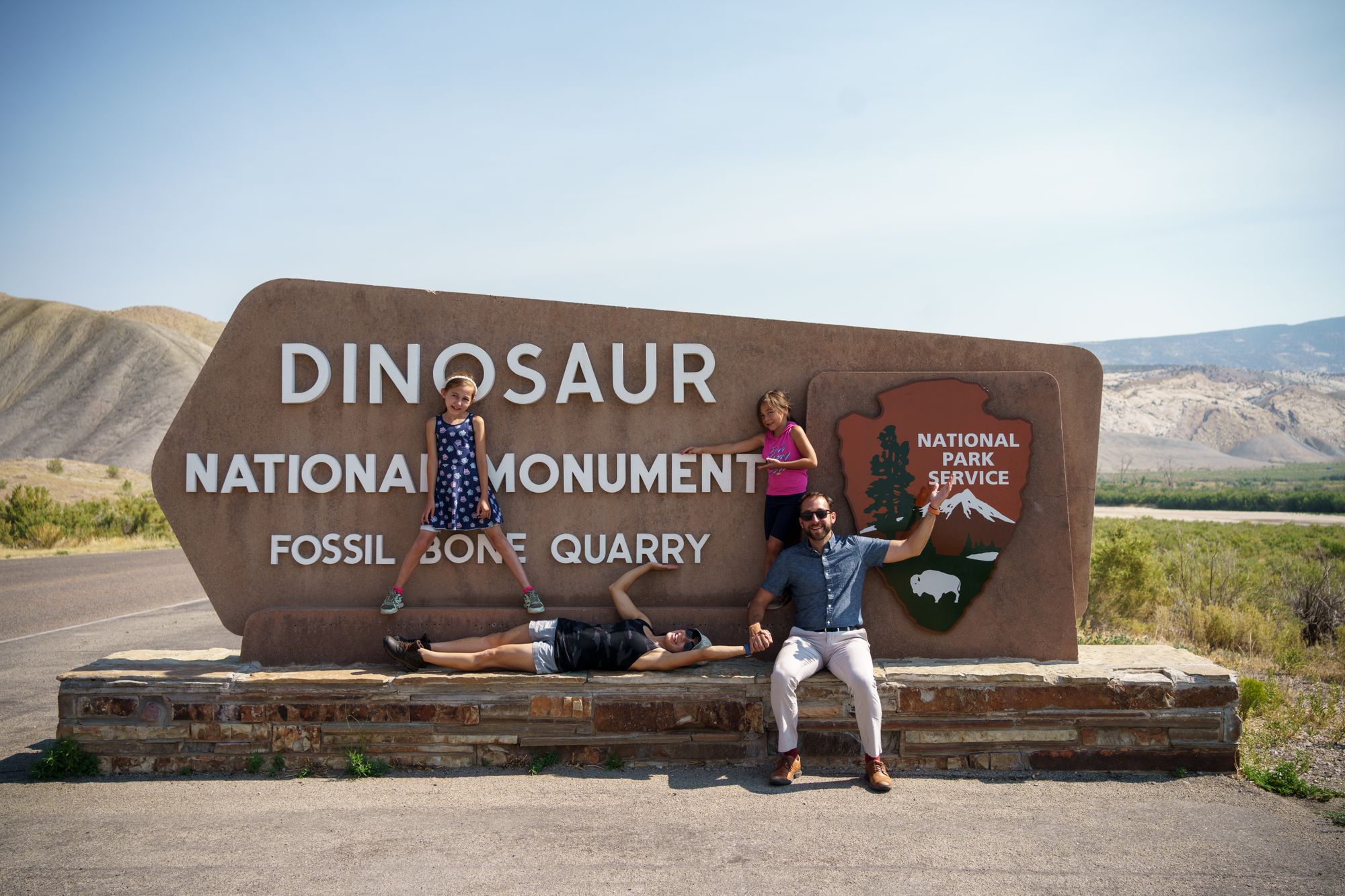 The Krycho family at the welcome sign for Dinosaur National Monument, summer 2021